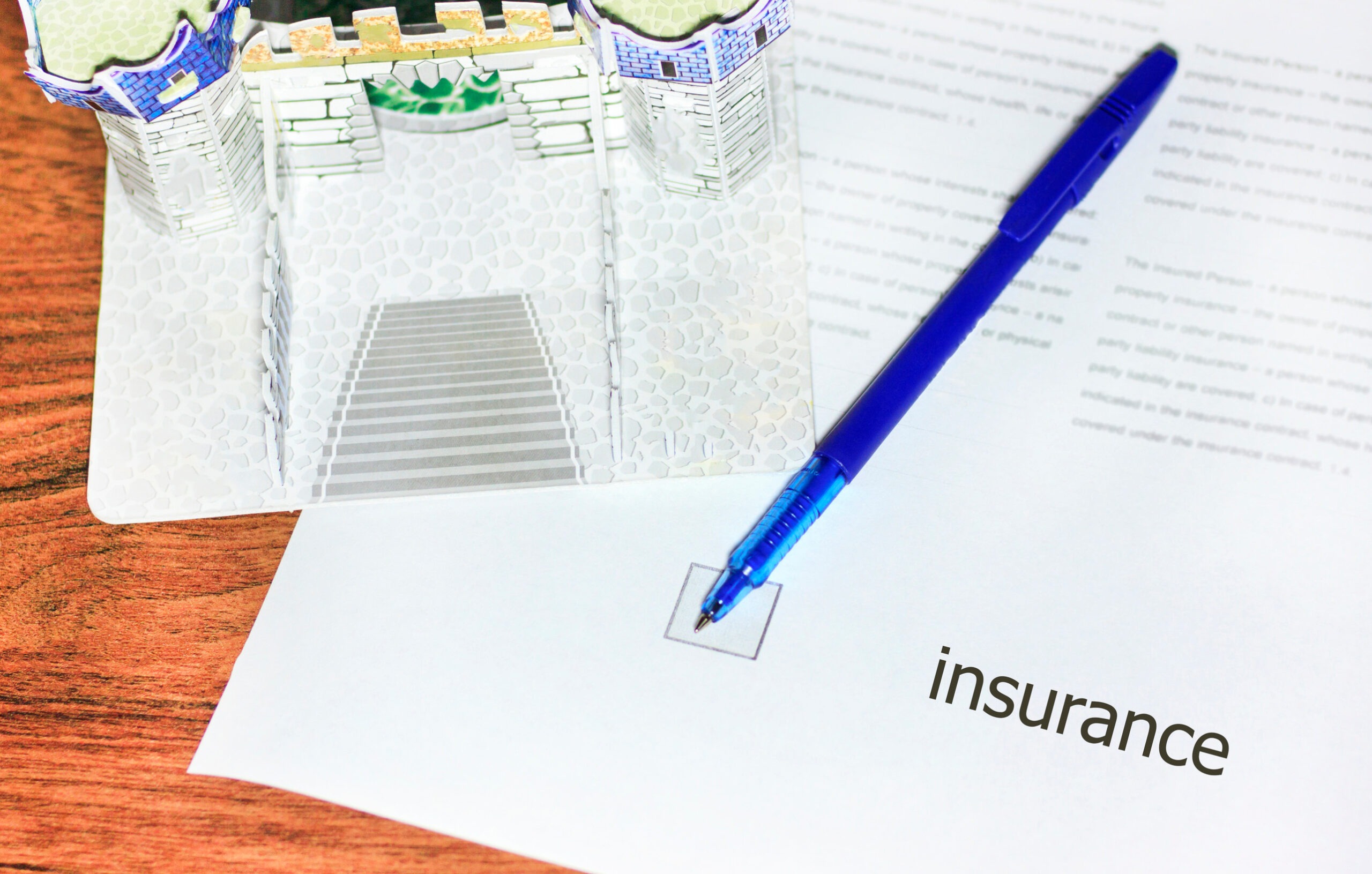 A blue pen rests on a paper labeled 